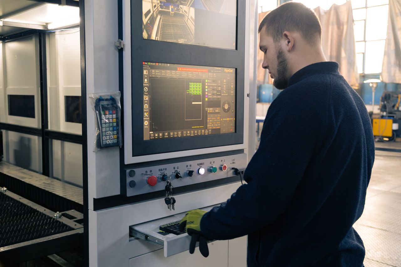 An operator at the laser's console, the cutting plan on screen