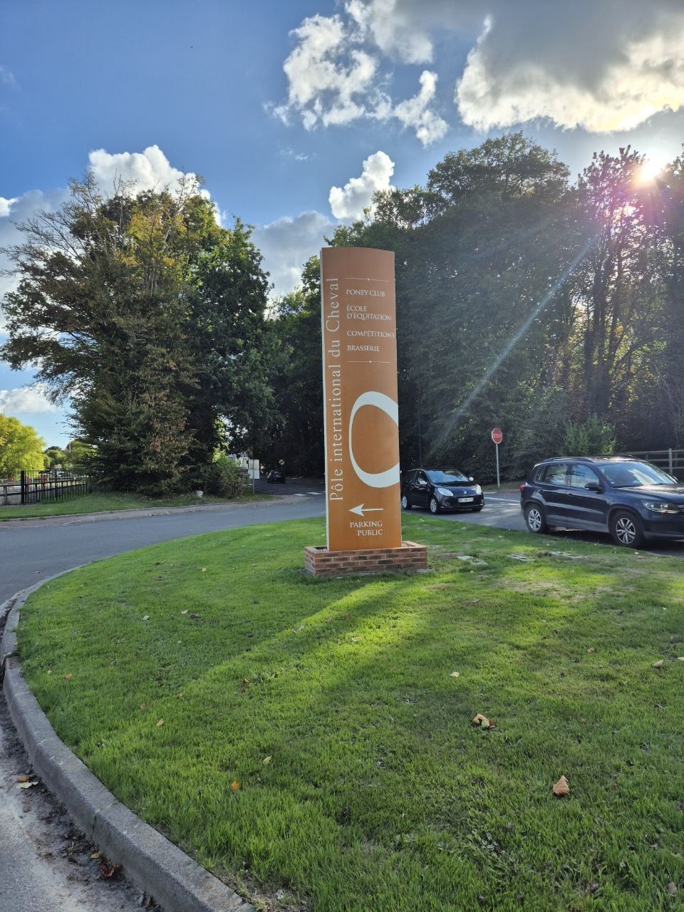 The roadside totem at the entrance to the Pôle International du Cheval, listing the pony club, the riding school, the competition grounds and the brasserie