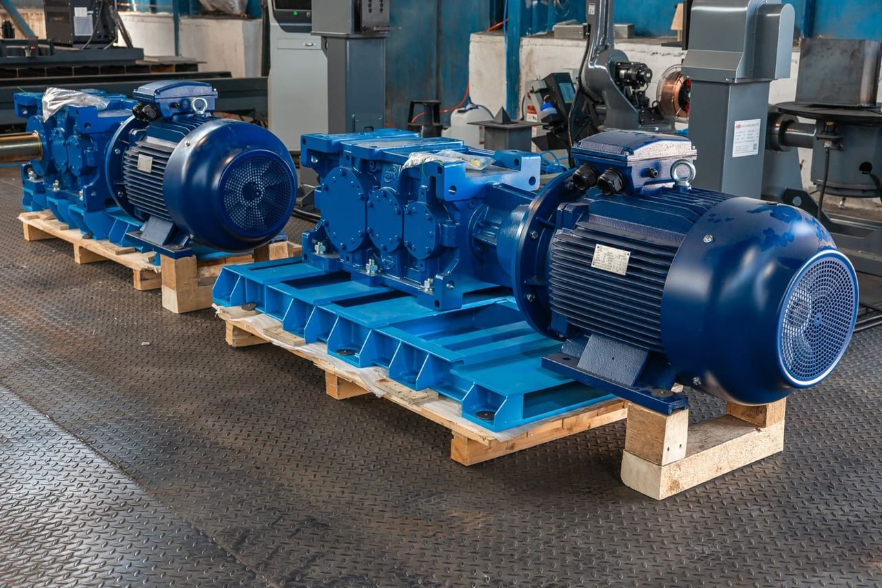 A gearbox and electric motor seated and levelled on a machine base frame